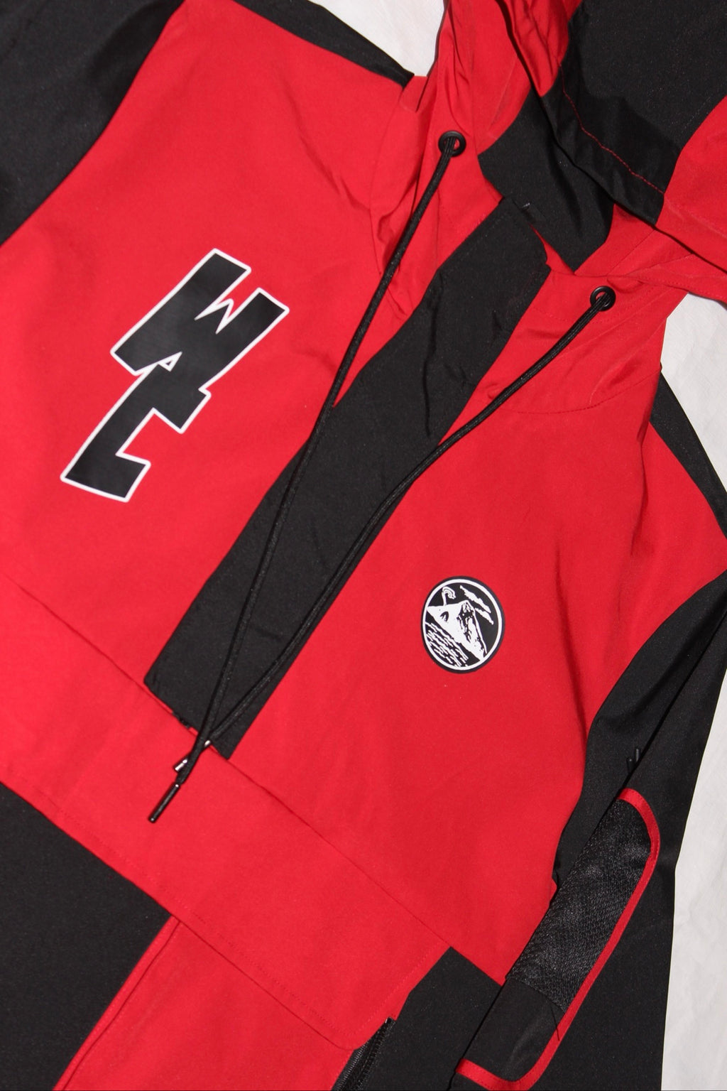 WCNY Windbreaker — Black & Red colorway, front detail with WC chest logo and patch