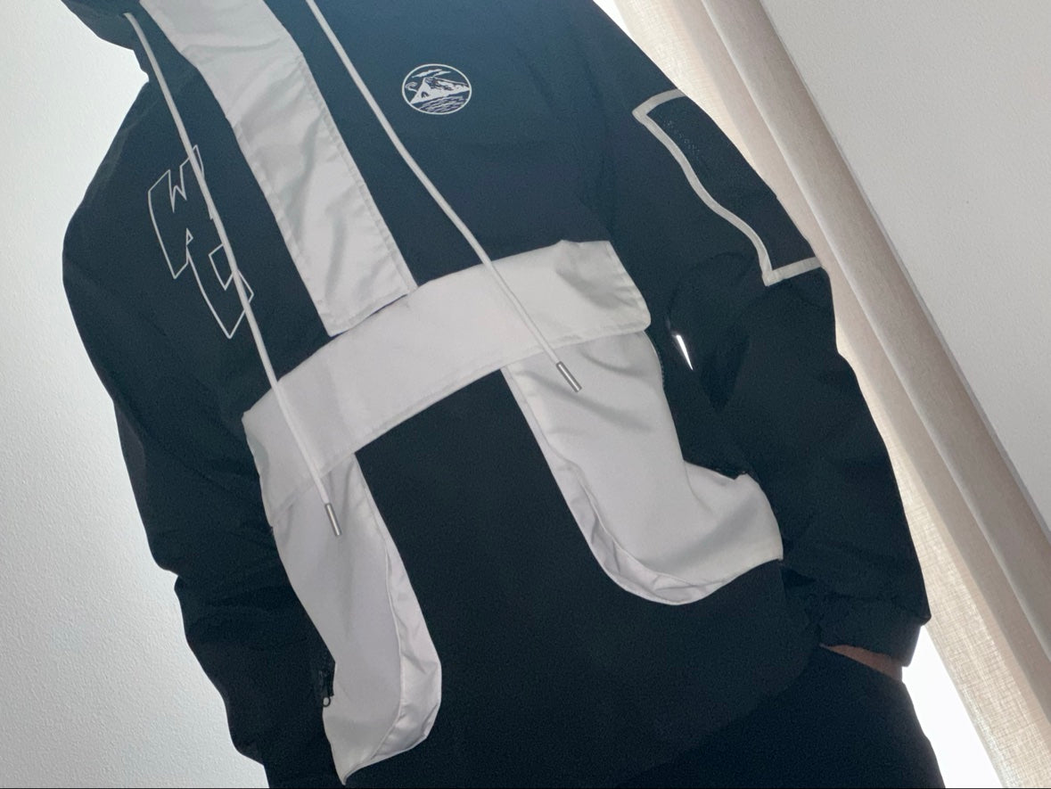 WCNY Windbreaker — Black & White colorway, front detail with WC chest logo and patch